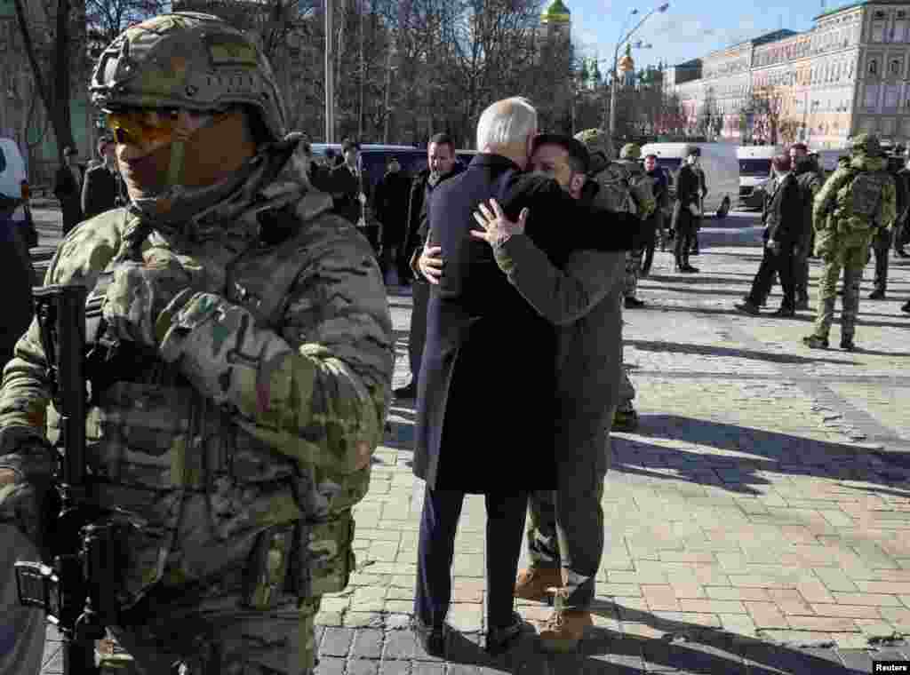 U.S. President Joe Biden and Ukraine&#39;s President Volodymyr Zelenskiy embrace after their visit to the Wall of Remembrance to pay tribute to killed Ukrainian soldiers, in Kyiv.