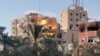Smoke and flames rise following an Israeli strike on a residential building, amid the ongoing conflict between Israel and Hamas, in Nuseirat in the central Gaza Strip, in this still picture taken from a video, July 24, 2024. 