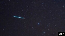FILE - A meteor from the Geminids meteor shower enters Earth's atmosphere on Dec. 12, 2009, above Southold, N.Y. A meteor streaked across New York City's skyline and disintegrated over nearby New Jersey on July 16, 2024. 
