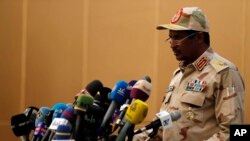 FILE - Gen. Mohamed Hamdan Dagalo, the deputy head of the military council speaks at a ceremony in Khartoum, Aug. 4, 2019. Sudan's paramilitary leader has announced plans to attend ceasefire talks in Switzerland arranged by the US and Saudi Arabia. 
