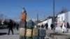FILE - Cans containing gasoline are kept for sale on a road in Kabul, Afghanistan, Jan. 27, 2022