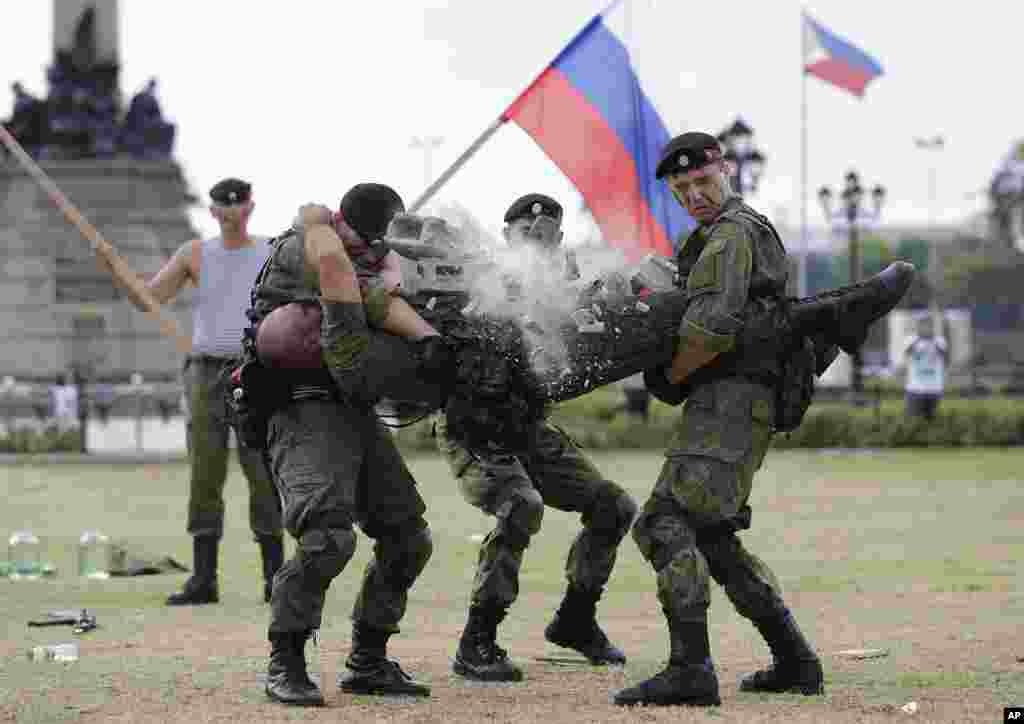 A Russian Marine uses a hammer to break a brick on top of his comrade&#39;s stomach during a Capability Demonstration at Manila&#39;s Rizal Park, the Philippines.