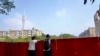 中国广东广州被封的海珠区居民从围栏里向往张望。（2022年11月11日）