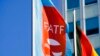 FILE - A flag with the logo of the Financial Action Task Force, FATF, waves in the wind during a meeting of the task force at the Congress Center in Berlin, Germany, June 17, 2022.