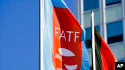 FILE - A flag with the logo of the Financial Action Task Force, FATF, waves in the wind during a meeting of the task force at the Congress Center in Berlin, Germany, June 17, 2022.