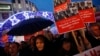 Supporters of main opposition Republican People's Party (CHP) hold placards with pictures of four former ministers while shouting anti-government slogans during a protest in Istanbul, Turkey, Dec. 17, 2014.