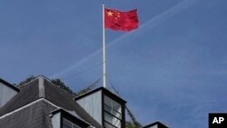 FILE - A Chinese national flag flies above China's Embassy in London, Sept. 11, 2023.
