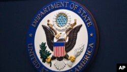 FILE - The State Department seal is seen on the briefing room lectern at the department in Washington, Jan. 31, 2022. 