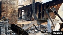 FILE - The remains of a house destroyed by bushfires are seen in the town of Kinglake, about 56km (35 miles) northeast of Melbourne, Feb. 16, 2009. Authorities said it would be weeks before they would be able to say that the fires are definitely out. 