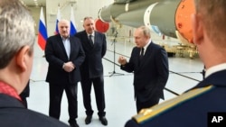 Russian President Vladimir Putin, right, Belarusian President Alexander Lukashenko, left, and Russian Roscosmos head Dmitry Rogozin visit the Vostochny cosmodrome outside the city of Tsiolkovsky, about 200 kilometers (125 miles) from the city of Blagovesh
