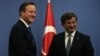 British Prime Minister David Cameron, left, and his Turkish counterpart, Ahmet Davutoglu, conclude a news conference in Ankara, Dec. 9, 2014. 