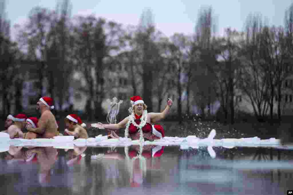 12月25日，柏林海豹冬泳俱乐部的成员在德国柏林部分结了冰的奥兰克湖参加一年一度的圣诞游泳活动 