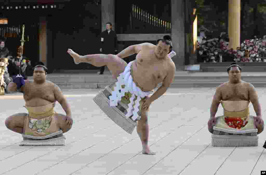 Newly promoted sumo grand champion Kisenosato performs his ring entry form at the Meiji Shrine in Tokyo. Kisenosato is the first Japanese wrestler to earn the coveted rank of &quot;yokozuna,&quot; grand champion, since 1998.