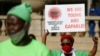 FILE - A Unemployed Graduate of South Africa holds a placard and raises her fist while staging a demonstration at Church Square in Pretoria, Aug. 14, 2020. 