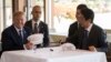 US President Donald Trump speaks with Japan's Prime Minister Shinzo Abe during a luncheon at the Kasumigaseki Country Club Gold Course in Tokyo, Nov. 5, 2017. The president and prime minister signed white hats reading “Donald and Shinzo Make Alliance Even
