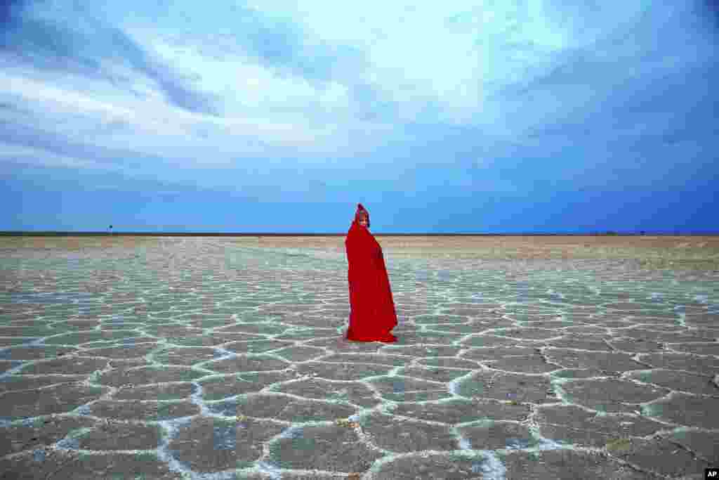 A woman visits Khour salt lake in the Mesr desert, about 305 miles (500 kilometers) southeast of the capital Tehran, Iran.