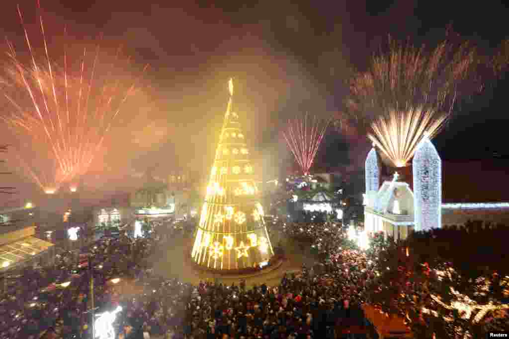 Fireworks are set off as a Christmas tree is illuminated in Dhour Shweir, Mount Lebanon, Dec. 10, 2016.