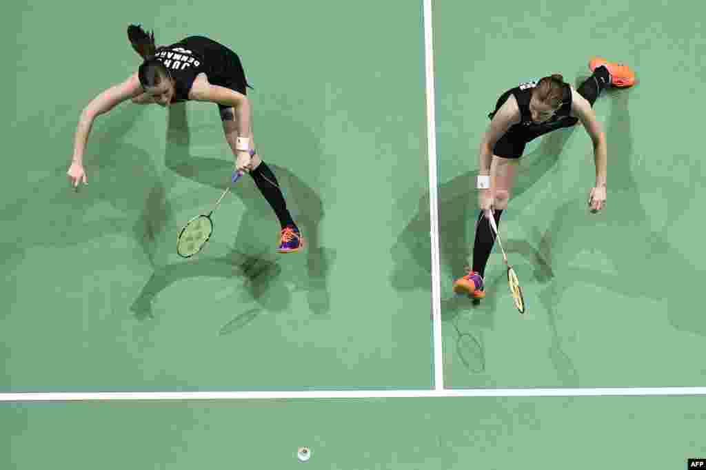 Kamilla Rytter Juhl and Christinna Pederson of Denmark play against Jung Kyung Eun and Shin Seung Chan of Korea during their women's double match on the third day of the Dubai World Super series Finals badminton tournament.