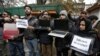 FILE - Kashmiri journalists display laptops and placards during a protest demanding restoration of internet service, in Srinagar, November 12, 2019. 