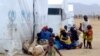 FILE - Nigerian refugees sit by a UNHCR tent in the refugee camp of Minawao, on the border of Nigeria at the extreme north of Cameroon, March 29, 2014. 