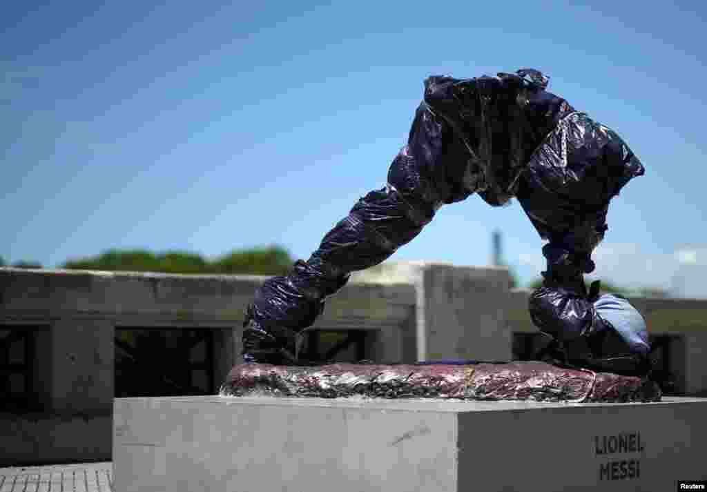 The statue of Argentina's soccer player Lionel Messi is seen covered after it was vandalized in Buenos Aires.