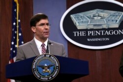 FILE - Defense Secretary Mark Esper speaks during a briefing at the Pentagon in Washington, March 2, 2020.