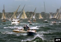 An armada of spectator craft churn up Sydney Harbour during the start of the 54th Sydney-to-Hobart ocean race, Dec. 26, 1998.