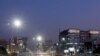 Vehicles drive past the commercial towers in Gurugram on the outskirts of New Delhi, India, Nov. 23, 2017. 