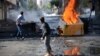 FILE - Youths set fire to barricades in Diyarbakir, Turkey, hours after Kurds protesting the Islamic State advance on Kobani, Syria, had clashed with police, Oct. 8, 2014. 