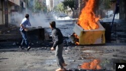 FILE - Youths set fire to barricades in Diyarbakir, Turkey, hours after Kurds protesting the Islamic State advance on Kobani, Syria, had clashed with police, Oct. 8, 2014. 