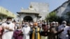 Indian Muslims wear masks and pray for the prevention of coronavirus during a special prayer after Friday prayers at a mosque in Ahmadabad, India, Jan. 31, 2020. 