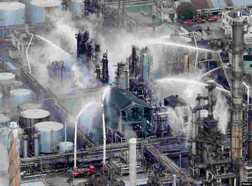 Fire trucks extinguish a fire at a TonenGeneral Sekiyu KK&#39;s oil refinery in Arida, Wakayama Prefecture, western Japan, in this photo taken by Kyodo.