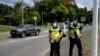 Gendarmes secure the road of Saint Michel, on the day of the vote for the referendum on independence, in Mont Dore, on the French South Pacific territory of New Caledonia on Dec. 12, 2021.