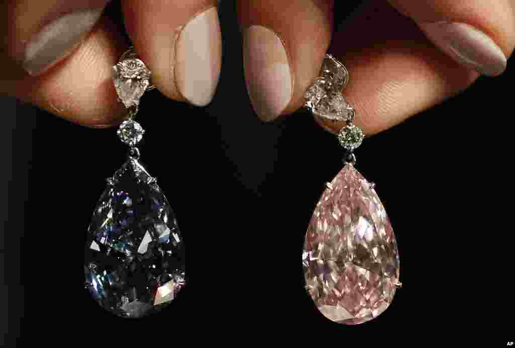 The Apollo blue diamond and the Artemis pink diamond earrings are displayed at Sotheby's auction rooms in London.
