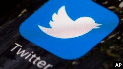 FILE - The Twitter app icon is seen on a mobile phone in Philadelphia, April 26, 2017.
