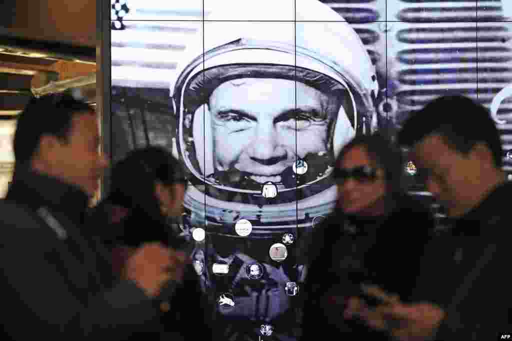 Tourists gather near a tribute to former astronaut and U.S. Senator John Glenn, at the National Air and Space Museum, in Washington, D.C. Glenn, who passed away Dec. 8, was the first American to orbit the earth.