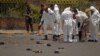 Forensic policemen inspect the site of a suicide bomb attack at a parade square in Sanaa, Yemen, May 21, 2012. 