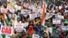 Women display placards during a protest, organized by West Bengal State Jamiat-e-Ulama, an Islamic organization, against a new citizenship law, in Kolkata, India, Dec. 22, 2019.