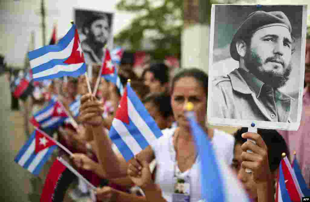 People wait for the ashes of Cuban leader Fidel Castro to be driven through the streets of Jimaguayu, Cuba, during their four-day journey across the island for the burial in Santiago de Cuba.