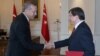 FILE - Turkish President Recep Tayyip Erdogan, left, and Prime Minister Ahmet Davutoglu shake hands, in Ankara, Turkey.