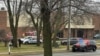 Emergency vehicles are parked outside the Abundant Life Christian School in Madison, Wis., where a shooting occurred, Dec. 16, 2024. A teacher, a student and the shooter were killed, police said.