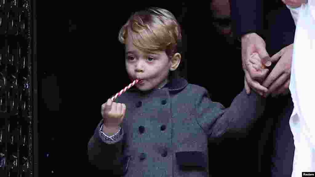 Prince George, the son of the Duke and Duchess of Cambridge, sucks a sweet as he leaves the morning Christmas Day service at St Mark&#39;s Church in Englefield, near Bucklebury in southern England.