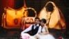 FILE - A couple pose for photos in front of a luxury shop in Hanoi, Vietnam.