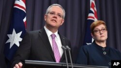Australian Prime Minister Scott Morrison, left, speaks to the media alongside Foreign Minister Marise Payne during a press conference at the Parliament House in Canberra, Oct. 16, 2018.