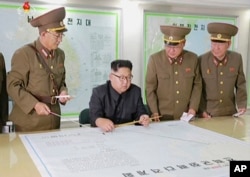 FILE - This image made from video of an August 2017 broadcast by North Korea's KRT shows North Korean leader Kim Jong Un receiving a briefing in Pyongyang.