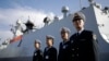 FILE - Chinese Navy officials stand in front of the ship Daqing.
