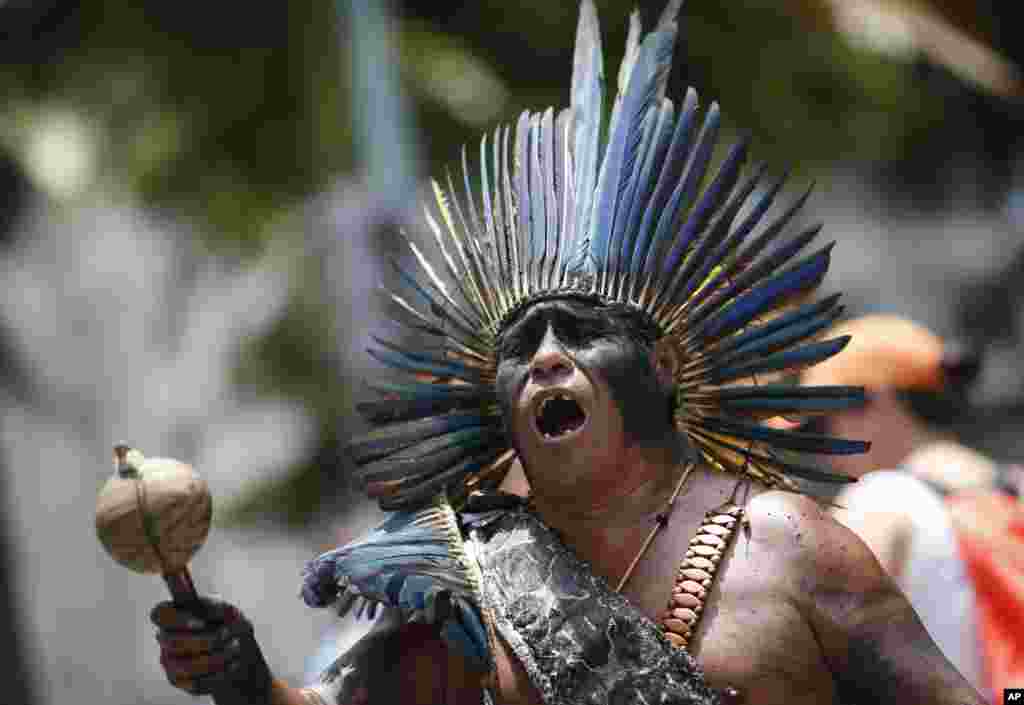 An indigenous man sings during a protest against austerity measures, outside the state legislature, in Rio de Janeiro, Brazil.
