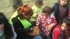 Volunteers painting nails of refugees at Idomeni