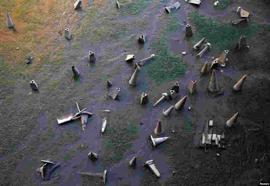 Traffic cones are seen on the bank of the River Thames during low tide in London, Britain.
