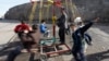 FILE - Turkish children are seen playing on a make-shift carousel.